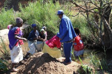 People in Zimbabwe constructing a micro hydro power plant and irrigation system