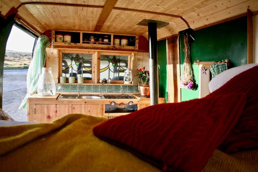 the inside of a selfbuilt campervan with stained glass