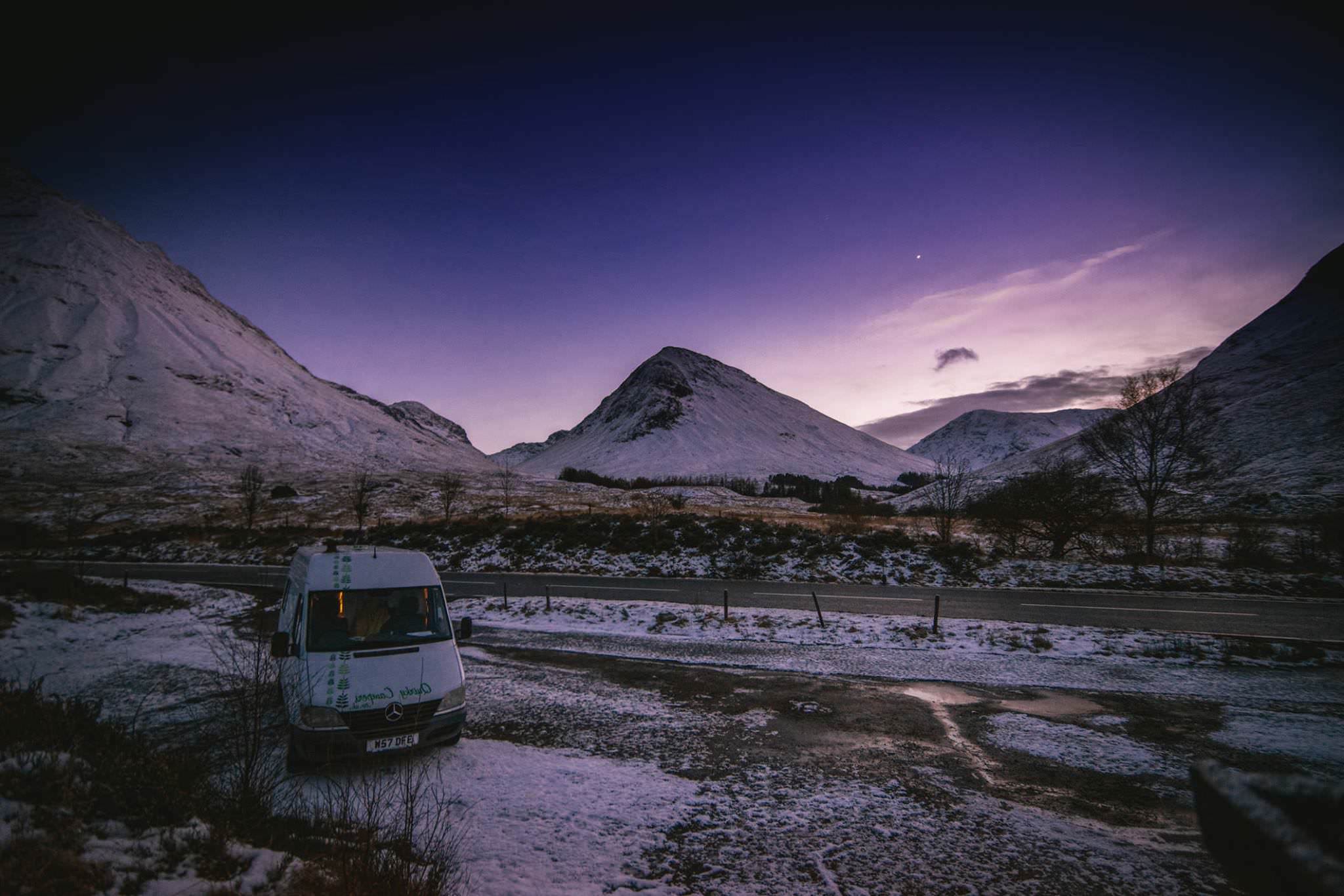 A Mercedes Sprinter parked up in a snowy mountain valley