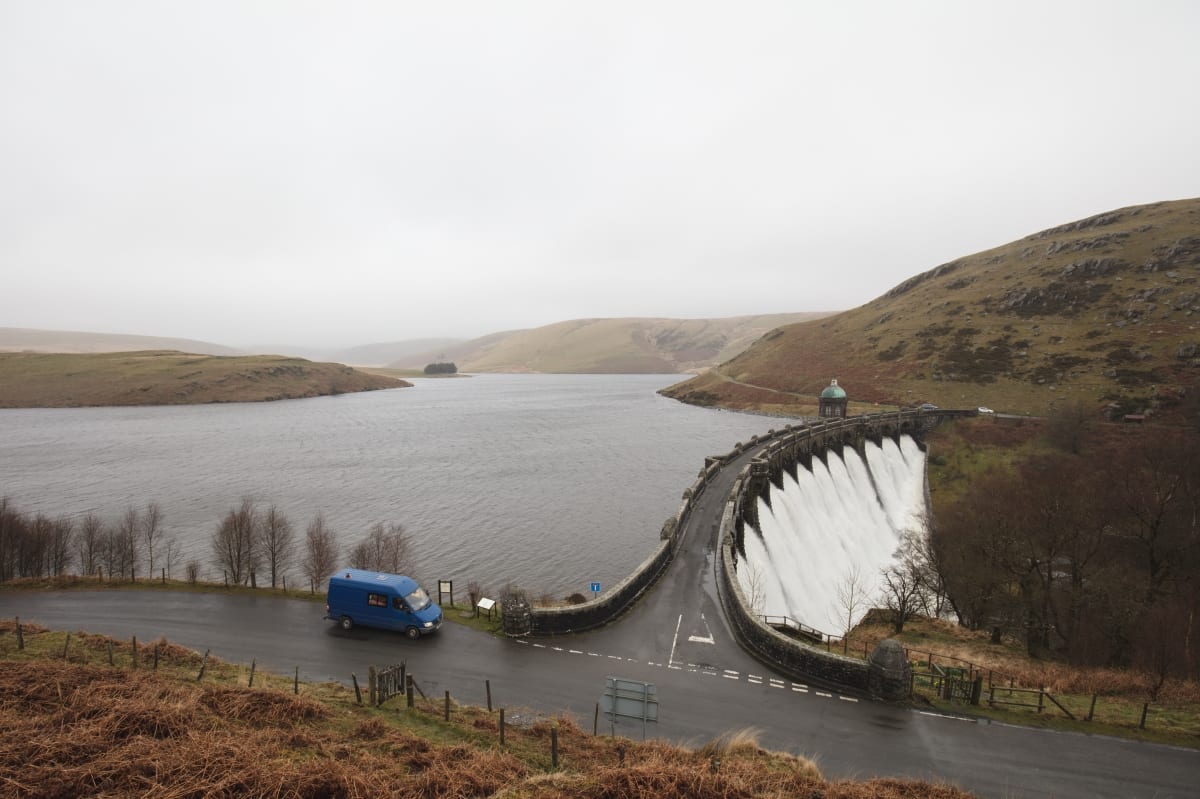 A campervan by a dam in Wales