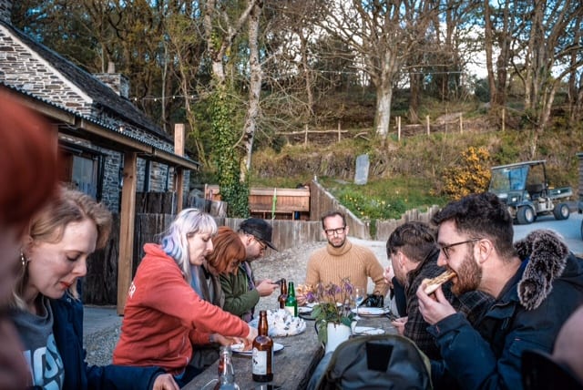 A group of friends eating and drinking at a festival in Wales
