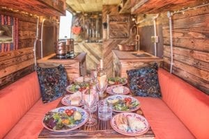 The dining area inside of a rustic handmade campervan