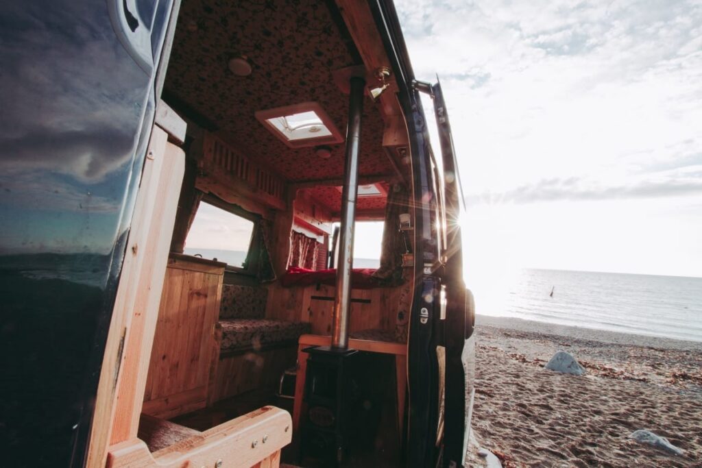 a selfbuilt campervan on a beach in wales