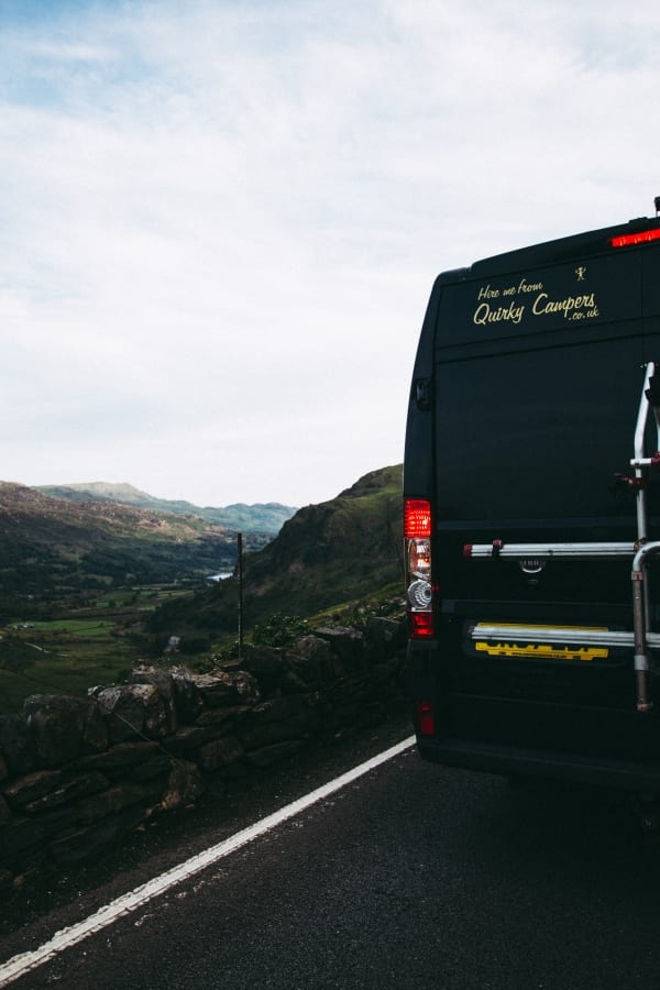 The back of a campervan overlooking the mountains in Wales
