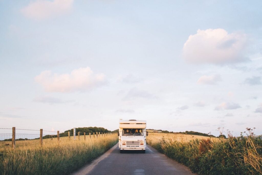 Tiki, Quirky Campers' retro campervan driving along a road in the New Forest