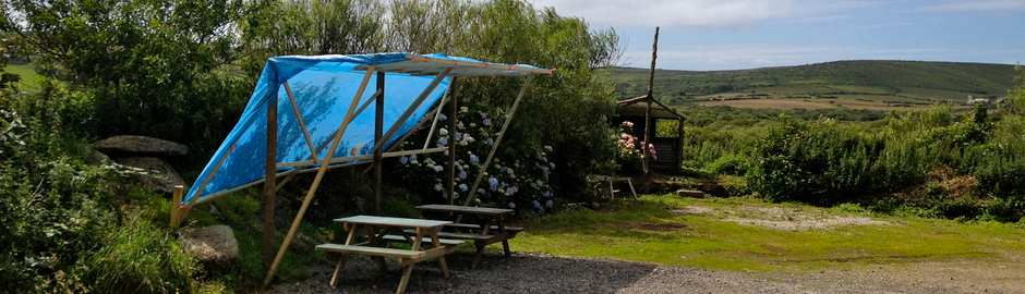 a campsite in cornwall with picnic tables