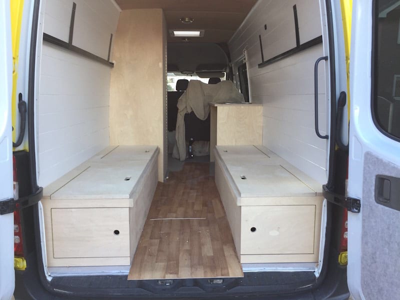 the seats being put into a sprinter van conversion