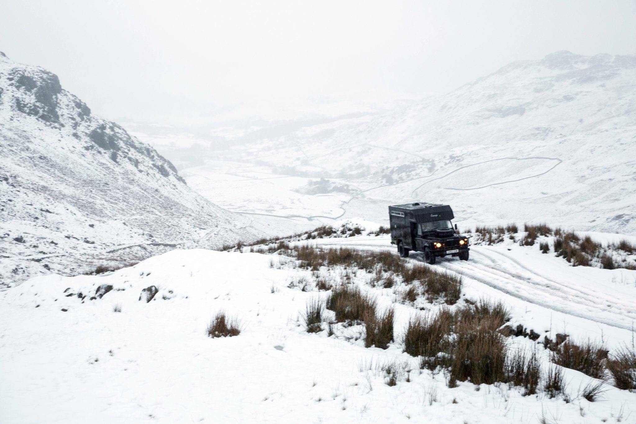 A landrover campervan in the snowy mountains