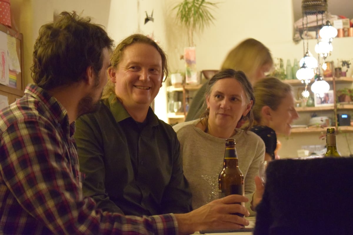 3 campervan owners having a chat with a beer