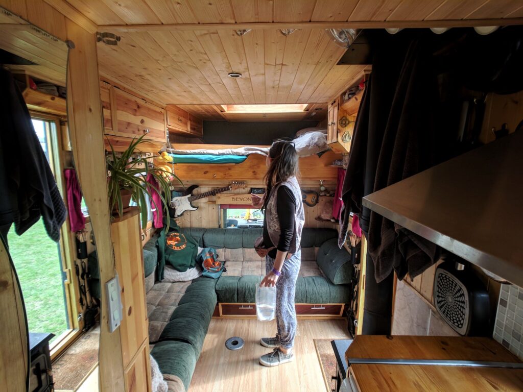 The inside of a selfbuilt campervan including bunk beds and living area