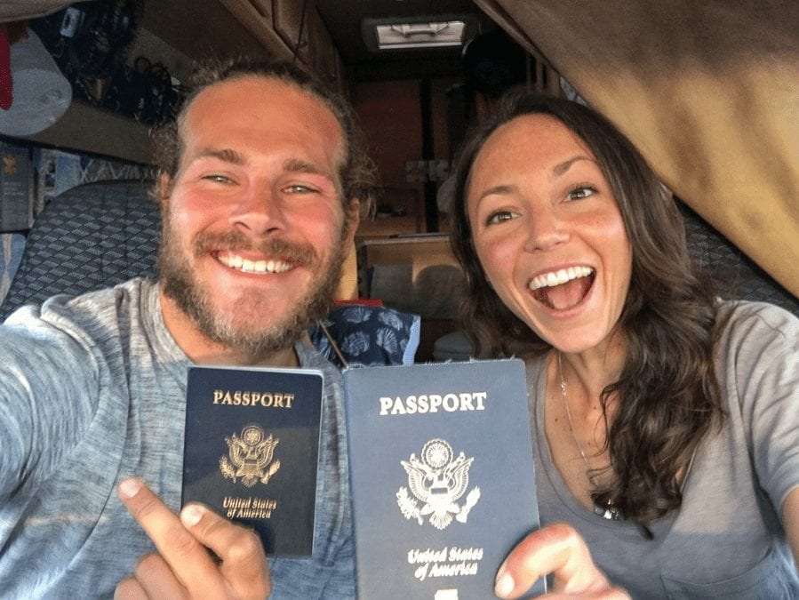 American couple traveling the UK in a campervan with their passports and smiles