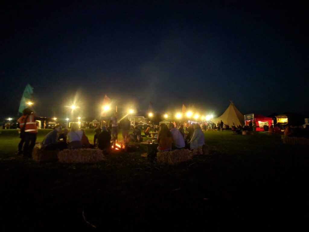 Sitting around a campfire at Camp Quirky, the UK's first selfbuilt campervan festival