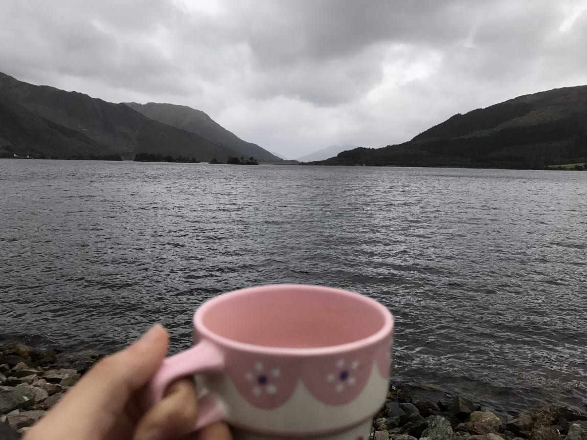 morning coffee mug overlooking Loch in Scotland