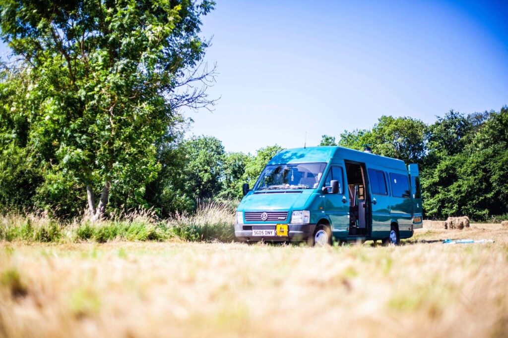 Blue campervan in a field
