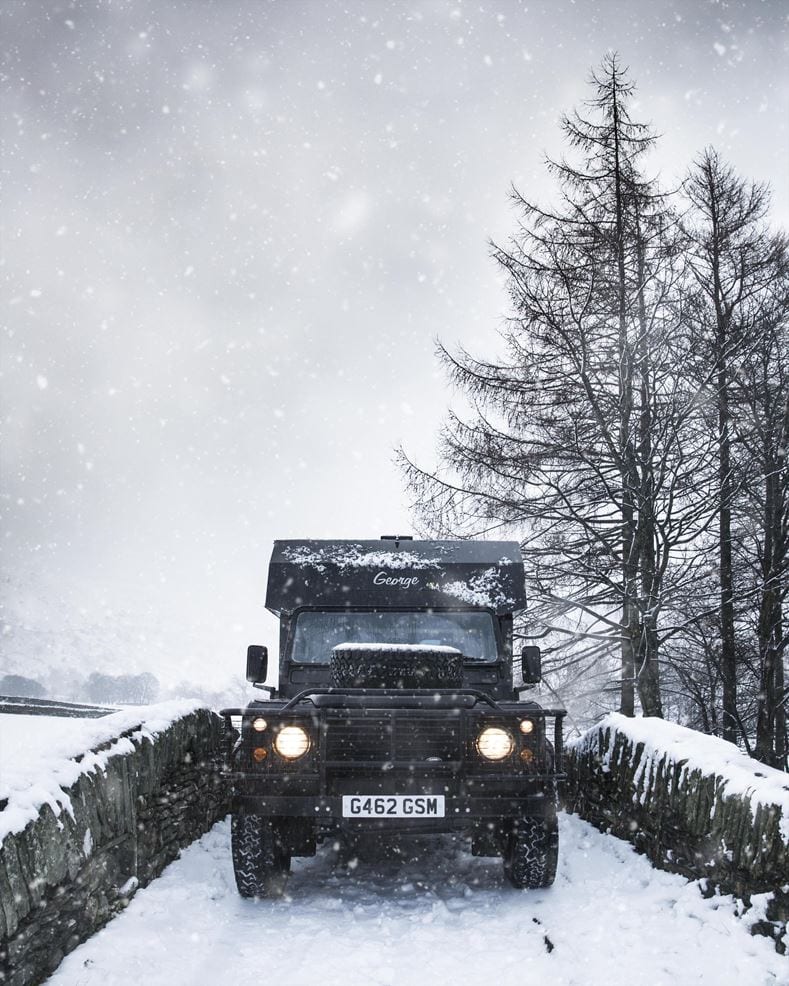 Land Rover Defender campervan in the snow