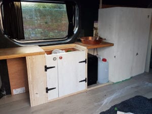 Campervan conversion with doors and cupbards