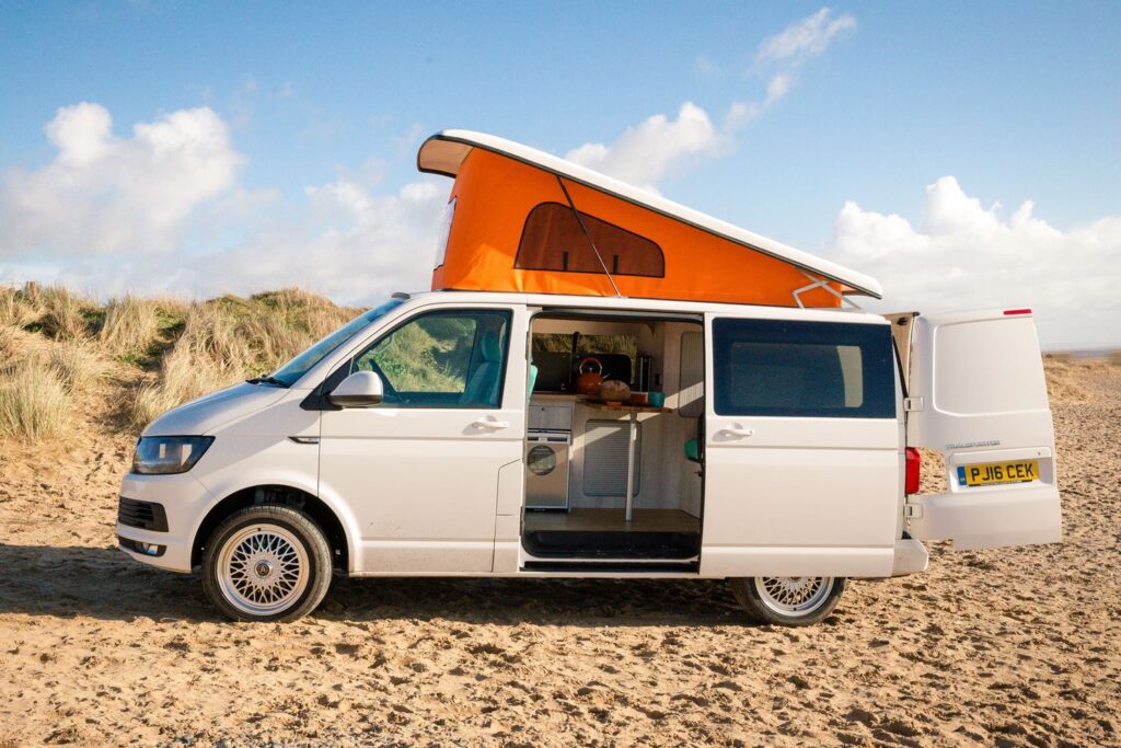 T5 campervan with pop top roof ont he beach