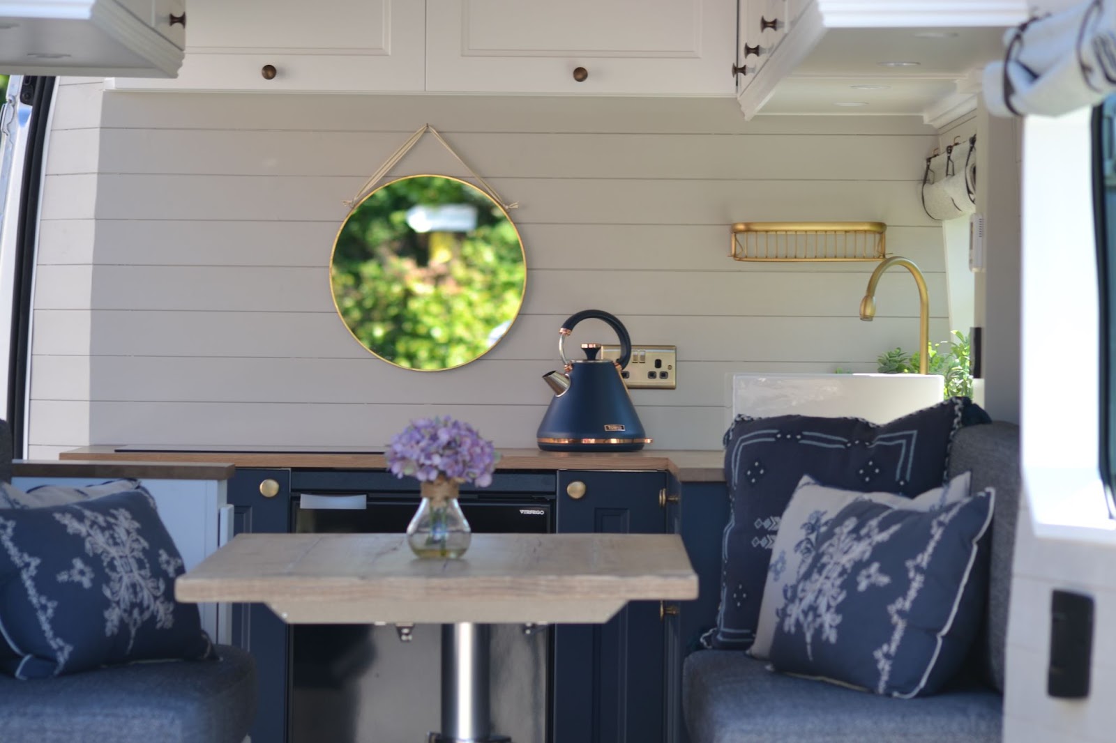 White campervan with kettle and mirror. 