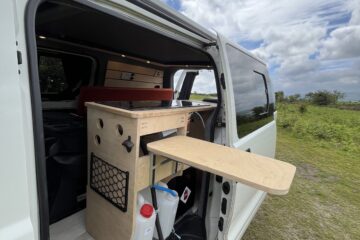 side door open showing kitchen with pull out table