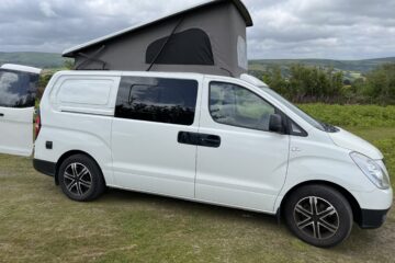 a pop top on a campervan in the countryside
